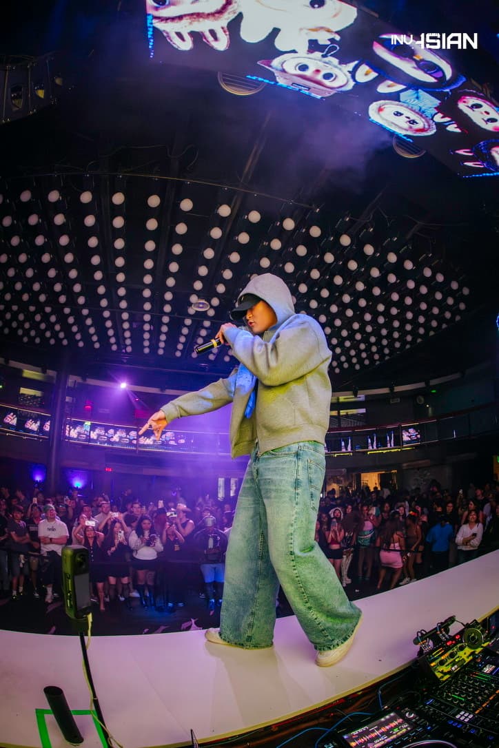 Sam Suen performing at District venue with fisheye lens